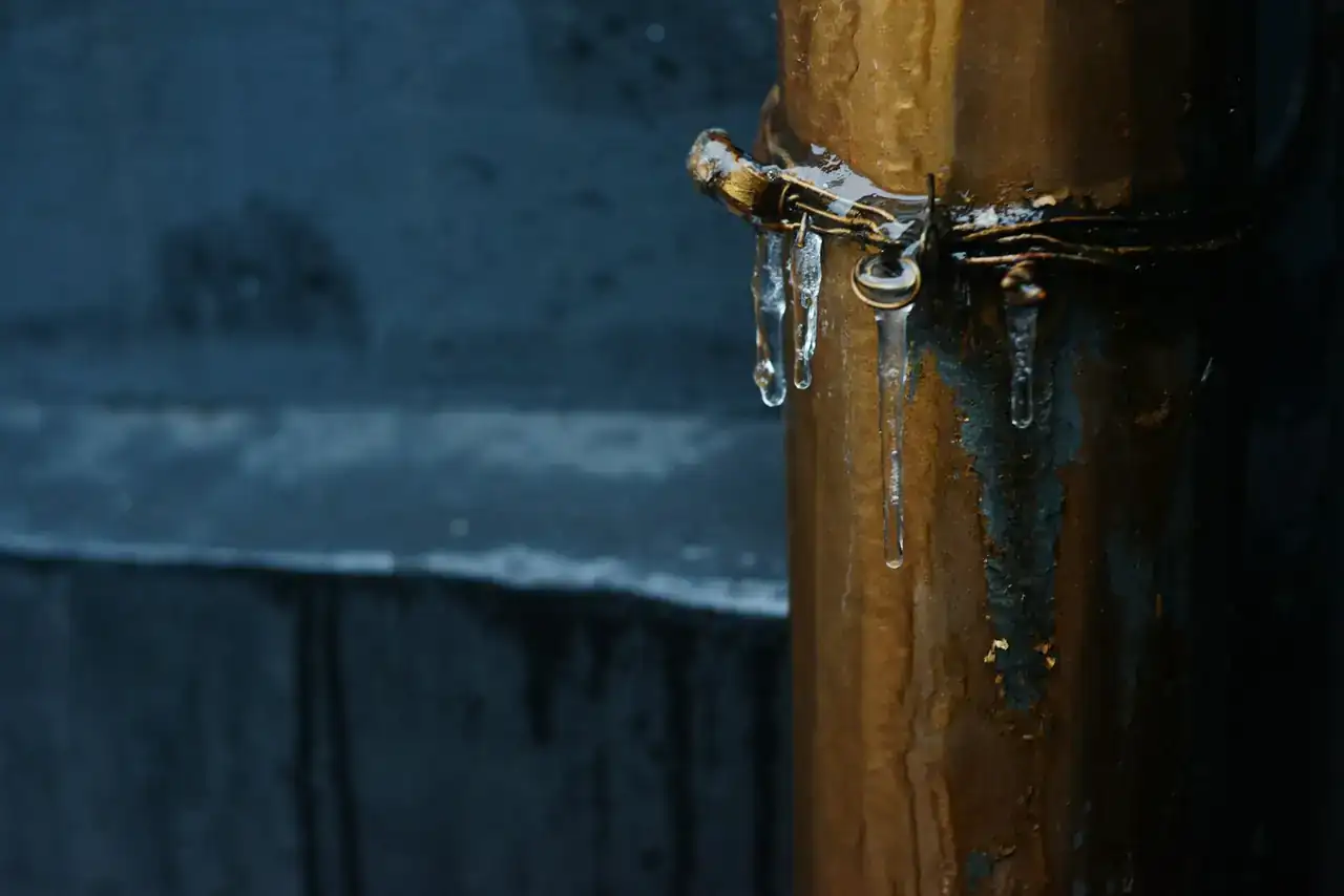 Ice forming on a copper pipe outdoors