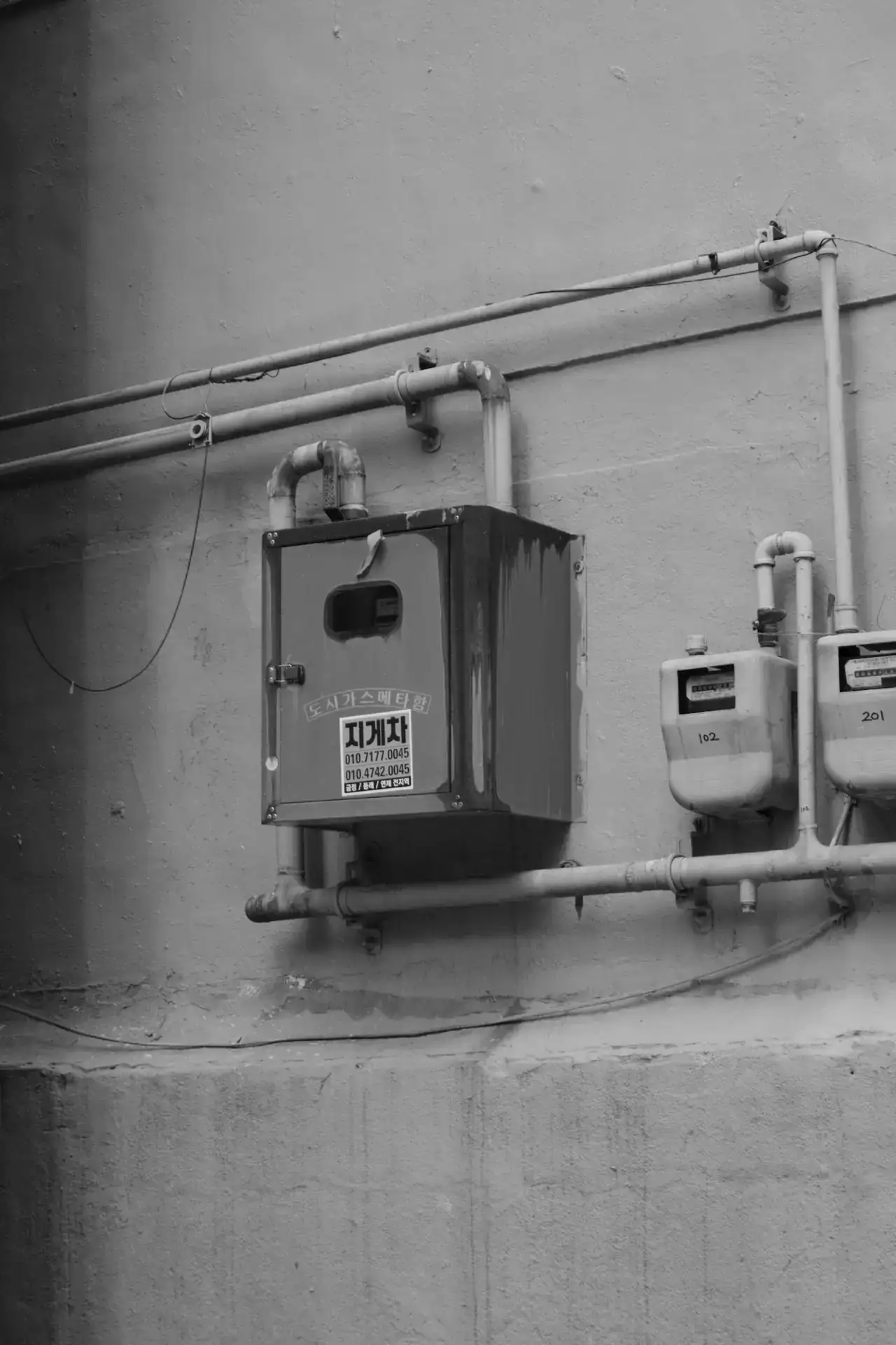 Gas meters and gas piping on an exterior wall